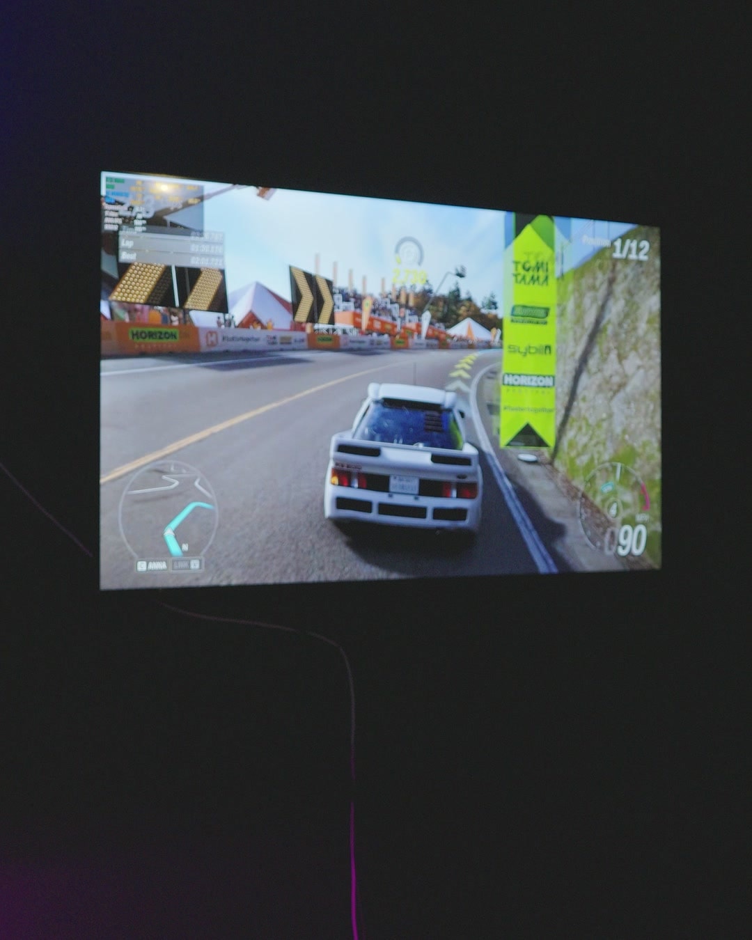 A racing game on a screen in the dark