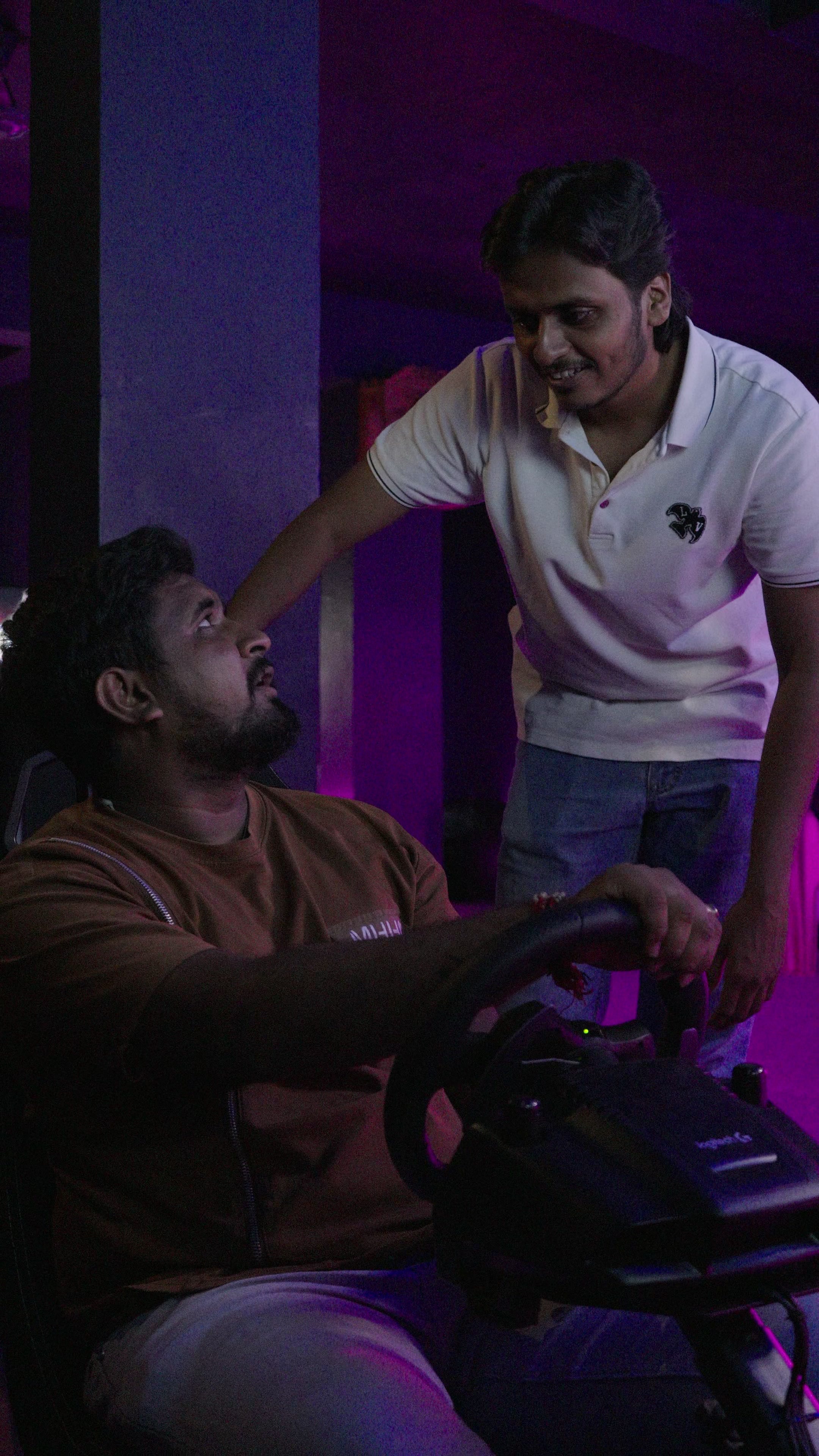 Two players at the racing simulator wheel